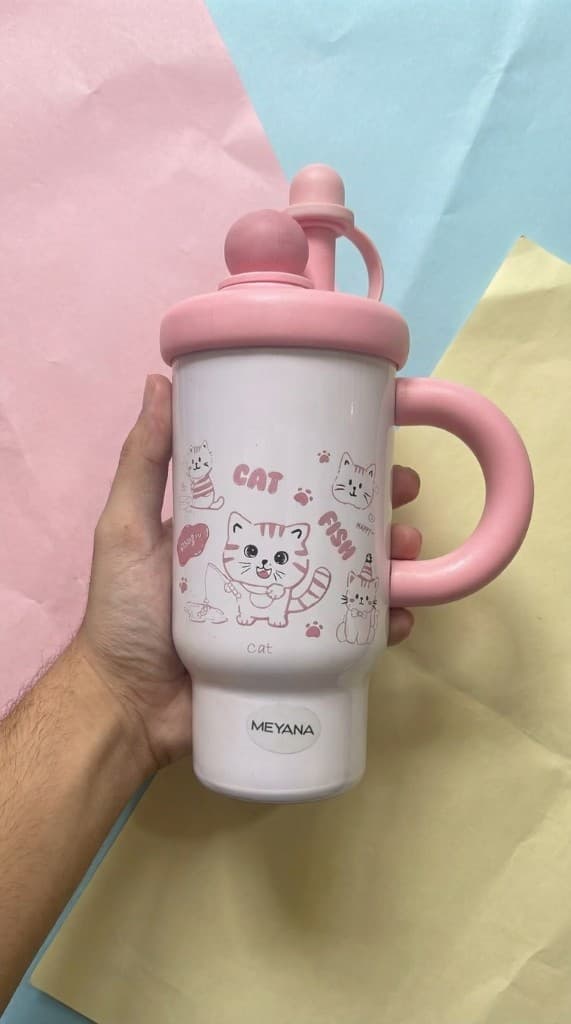 Cat Fish tumbler held against pastel paper